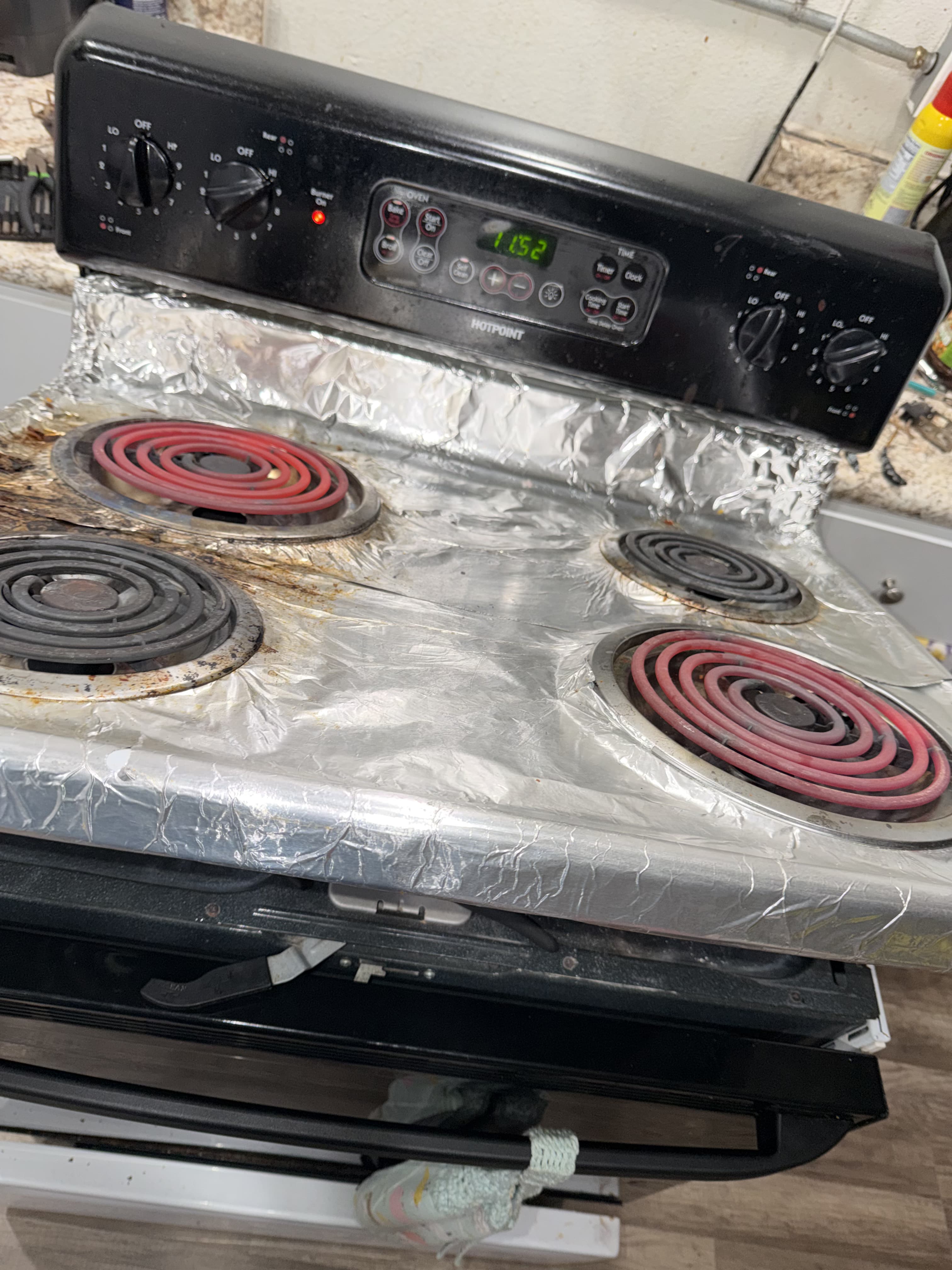 Hotpoint electric range with coil burners glowing red during heat testing