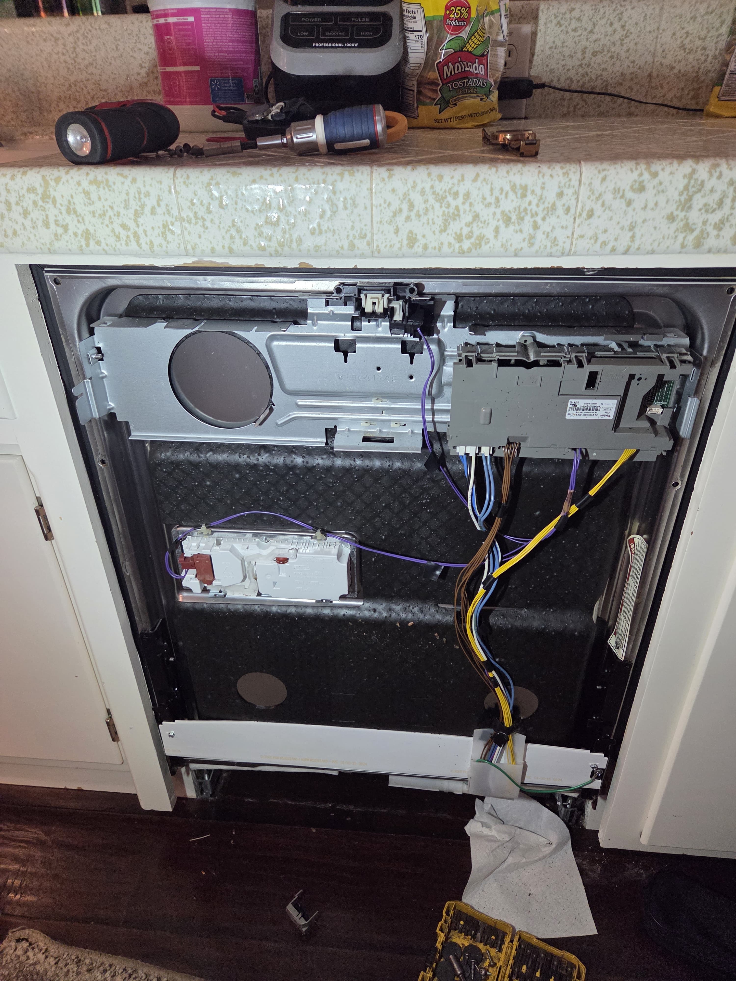 New control board installed in the Kenmore dishwasher door before reassembly