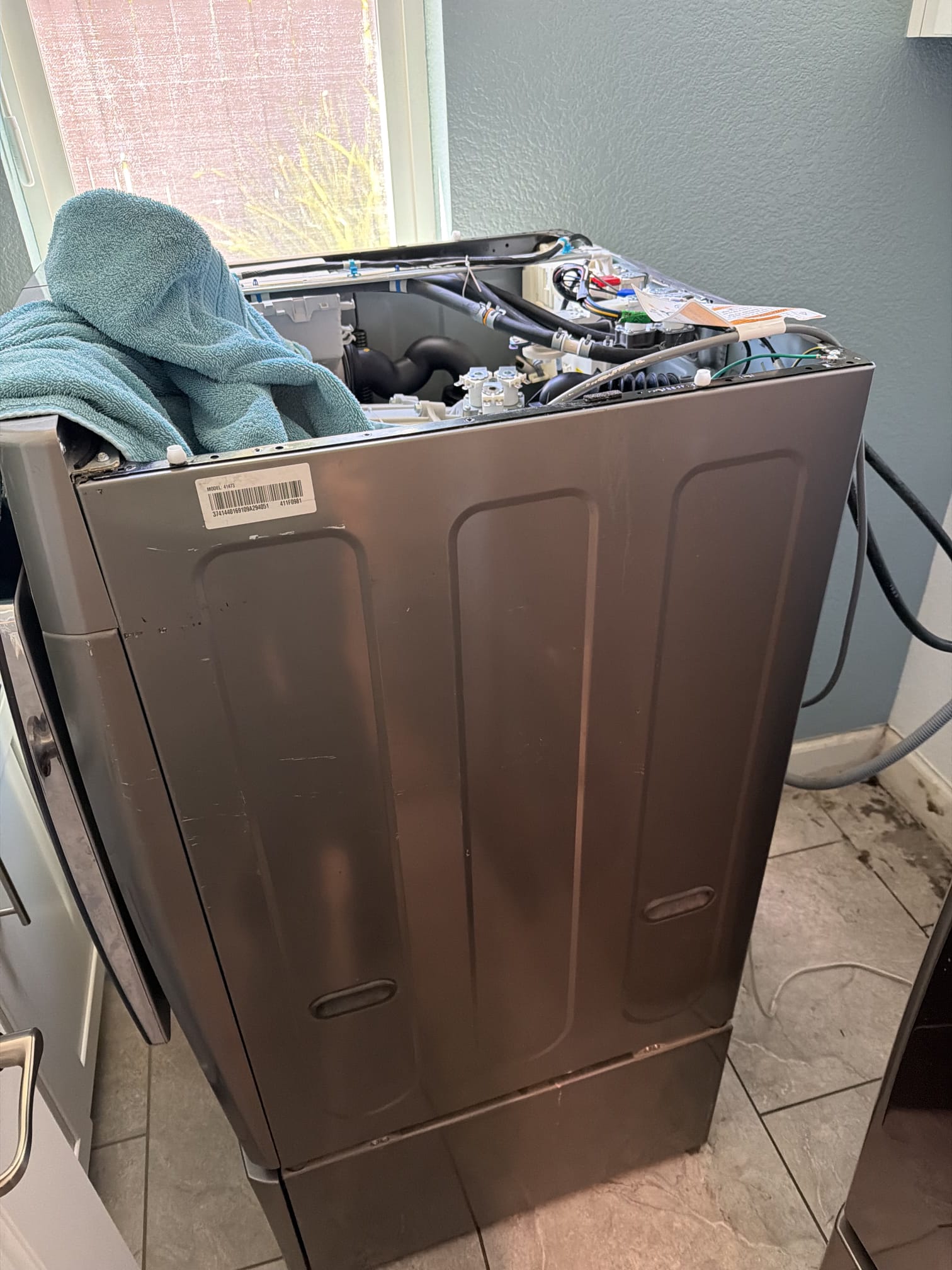 Kenmore Elite washer with the top panel open during the water inlet valve repair